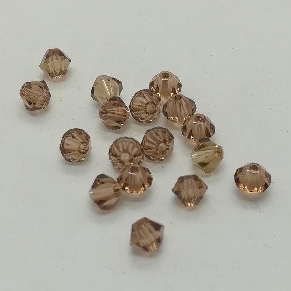 Swarovski - Cristalli bi-cono 4 mm - Light Smoked Topaz (10 pz)
