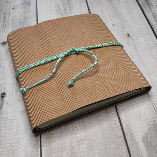 Custodia dell'album foto realizzato a mano con la tecnica della rilegatura belga, rivestito con carta Lokta stampata e cucitura a vista. Interno con 20 fogli (40 facciate) avorio e 1 tasca con soffietto contenente degli elementi di carta in tinta che possono essere utilizzati per decorare le pagine: ritagli, tags, etichette, fiori e foglie.